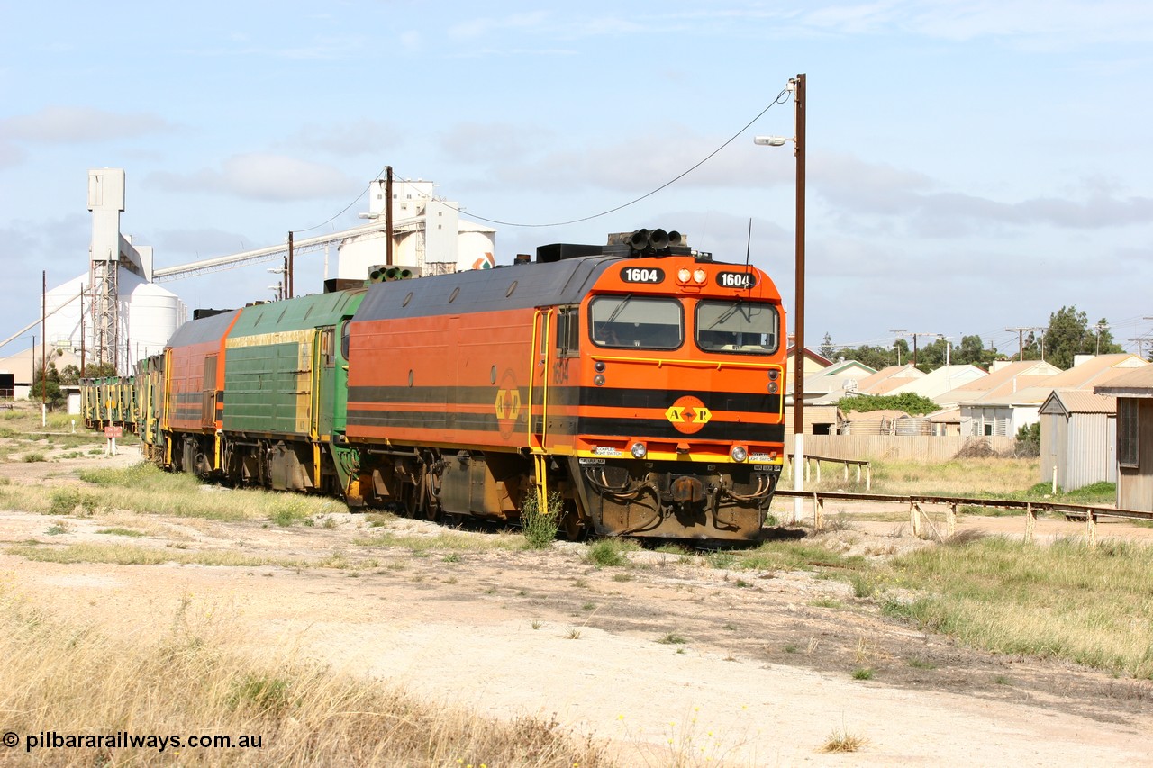 060113 2472
Thevenard, narrow gauge loco 1604 departs the yard with empty train 6DD3, 1604 leads a triple consist of Clyde Engineering built EMD JL22C model 1600 / NJ class combination of 1604 serial 71-731 and originally NJ 4, NJ 3 serial 71-730 and 1601 serial 71-728 the original class leader NJ 1, all three units started on the Central Australia Railway in 1971 and were transferred to the Eyre Peninsula in 1981. 1604 and 1601 both renumbered in 2004. 13th January 2006.
Keywords: 1600-class;1604;Clyde-Engineering-Granville-NSW;EMD;JL22C;71-731;NJ-class;NJ4;