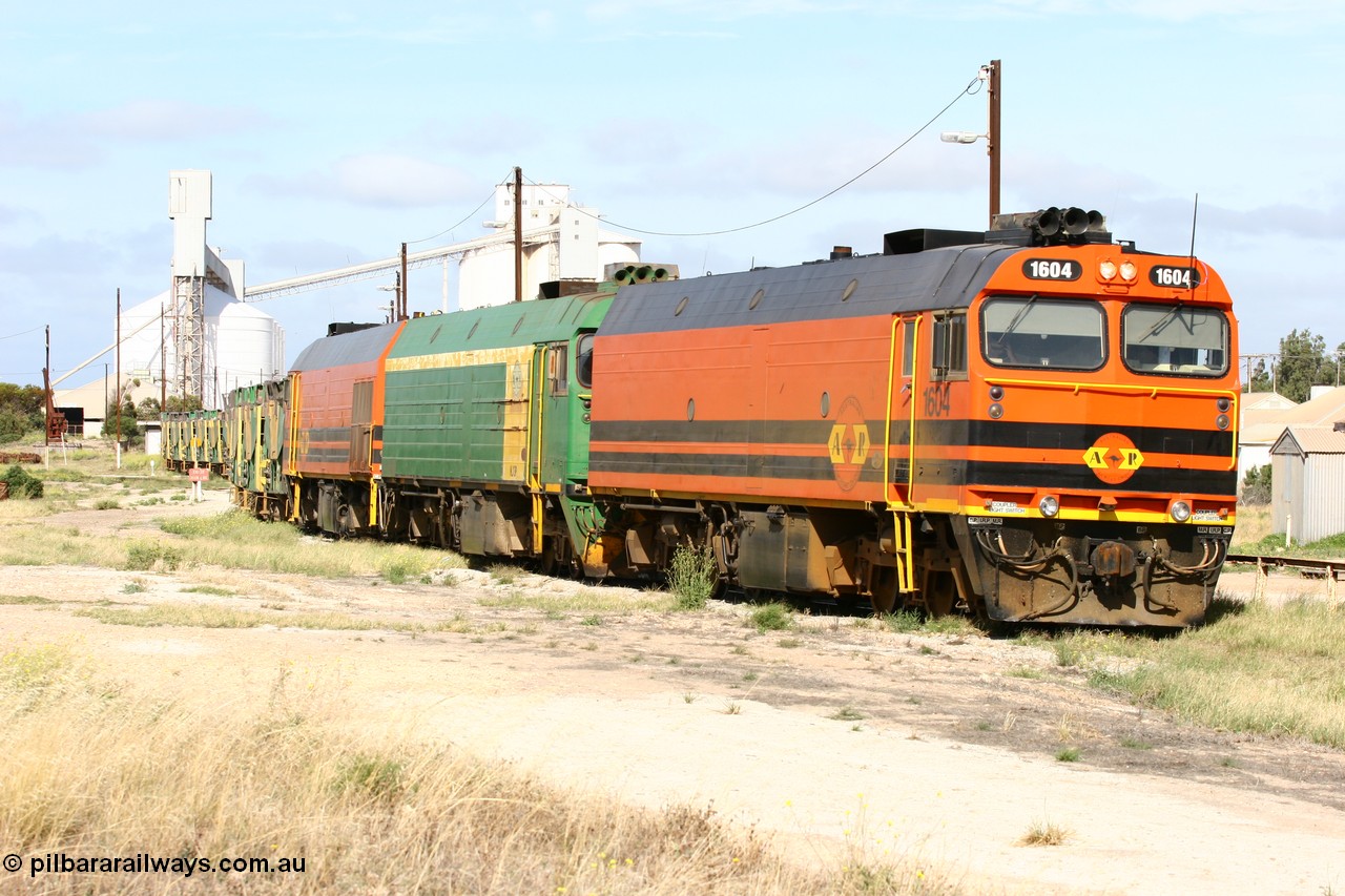 060113 2473
Thevenard, narrow gauge loco 1604 departs the yard with empty train 6DD3, 1604 leads a triple consist of Clyde Engineering built EMD JL22C model 1600 / NJ class combination of 1604 serial 71-731 and originally NJ 4, NJ 3 serial 71-730 and 1601 serial 71-728 the original class leader NJ 1, all three units started on the Central Australia Railway in 1971 and were transferred to the Eyre Peninsula in 1981. 1604 and 1601 both renumbered in 2004. 13th January 2006.
Keywords: 1600-class;1604;Clyde-Engineering-Granville-NSW;EMD;JL22C;71-731;NJ-class;NJ4;