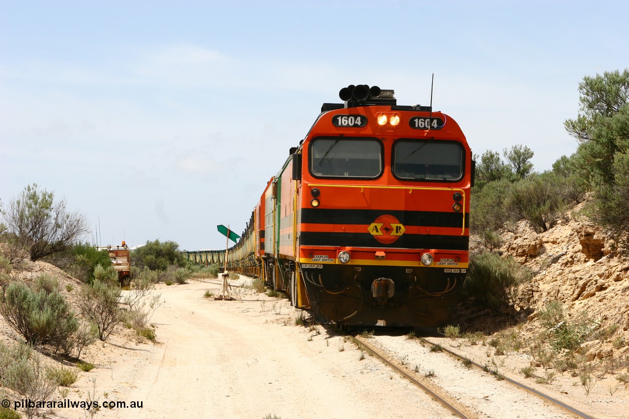 060113 2502
Kevin, narrow gauge loco 1604 leads NJ 3 and 1601 with empty train 6DD3 as they have arrived at Kevin and use the line to Penong (closed) to shunt back onto the triangle, and no, the locos didn't tip over! 13th January 2006.
Keywords: 1600-class;1604;Clyde-Engineering-Granville-NSW;EMD;JL22C;71-731;NJ-class;NJ4;