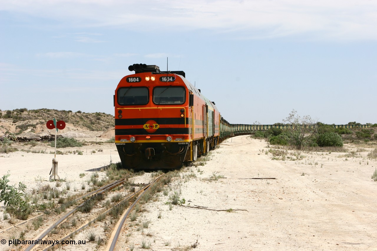 060113 2538
Kevin, 1600 class unit 1604 in Australian Railroad Group livery a Clyde Engineering built EMD JL22C model serial 71-731, originally built as NJ class NJ 4 and built for the Central Australia Railway in 1971, transferred to the Eyre Peninsula in 1981, shunts back along the Penong line with the points indicator set for the siding and the goods siding on the right of the train. [url=https://goo.gl/maps/JyRQW]Kevin station area[/url], as the train is reversed prior to loading on the mainline to Thevenard. 13th January 2006.
Keywords: 1600-class;1604;Clyde-Engineering-Granville-NSW;EMD;JL22C;71-731;NJ-class;NJ4;