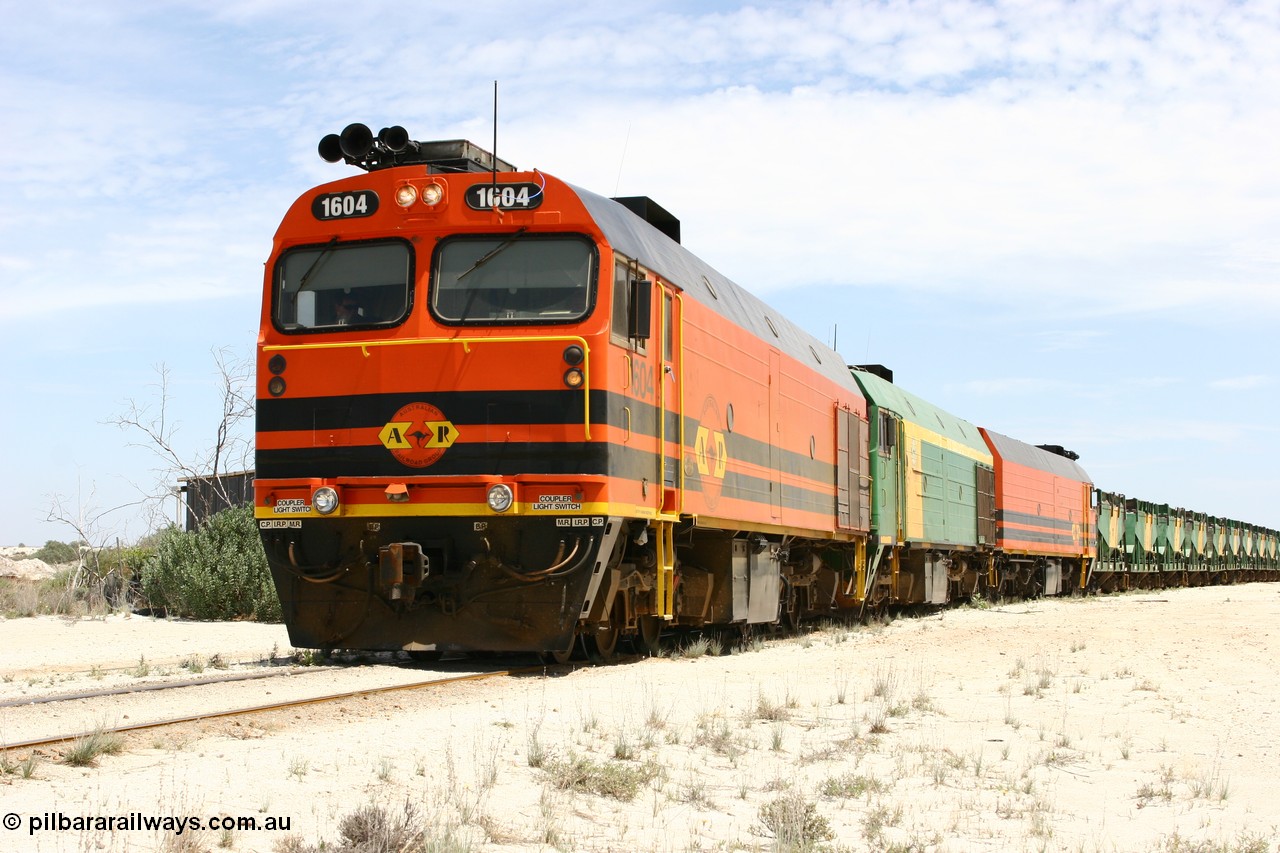 060113 2546
Kevin, narrow gauge locos 1604, NJ 3 and 1601 take the mainline to Thevenard, having reversed train 6DD3 on the Kevin triangle as they prepare to load, 1600 class unit 1604 in Australian Railroad Group livery a Clyde Engineering built EMD JL22C model serial 71-731, originally built as NJ class NJ 4 and built for the Central Australia Railway in 1971, transferred to the Eyre Peninsula in 1981. 13th January 2006.
Keywords: 1600-class;1604;Clyde-Engineering-Granville-NSW;EMD;JL22C;71-731;NJ-class;NJ4;