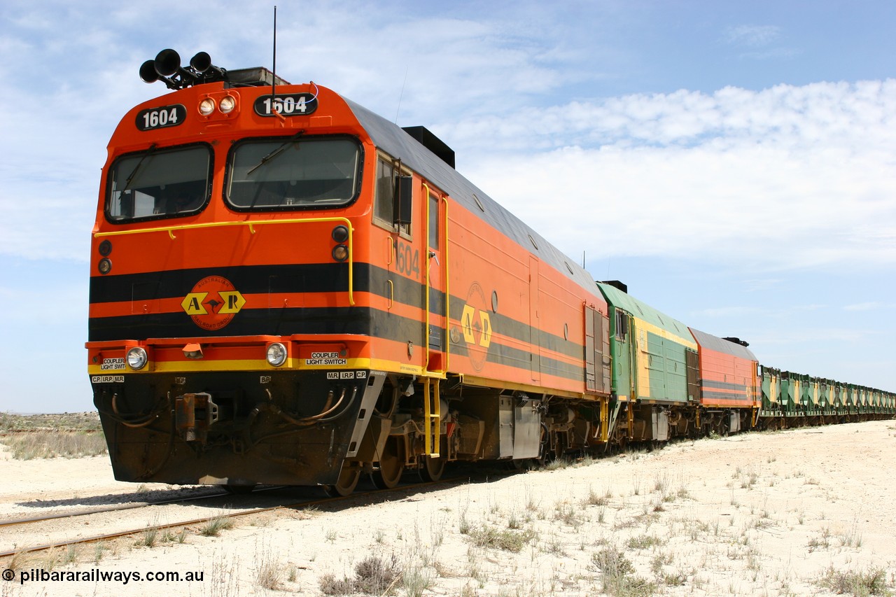 060113 2548
Kevin, narrow gauge locos 1604, NJ 3 and 1601 take the mainline to Thevenard, having reversed train 6DD3 on the Kevin triangle as they prepare to load, 1600 class unit 1604 in Australian Railroad Group livery a Clyde Engineering built EMD JL22C model serial 71-731, originally built as NJ class NJ 4 and built for the Central Australia Railway in 1971, transferred to the Eyre Peninsula in 1981. 13th January 2006.
Keywords: 1600-class;1604;Clyde-Engineering-Granville-NSW;EMD;JL22C;71-731;NJ-class;NJ4;