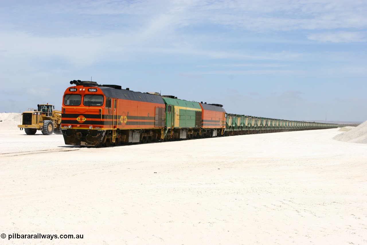 060113 2549
Kevin, standing on the mainline to Thevenard, and the train now identified as 6DD4 has commenced loading of gypsum but the 988 Cat front end loaders which takes about one and half hours to load. As the train reversed on the triangle the consist is the same heading back loaded with 1604 leading NJ 3 and 1601. 13th January 2006.
Keywords: 1600-class;1604;Clyde-Engineering-Granville-NSW;EMD;JL22C;71-731;NJ-class;NJ4;