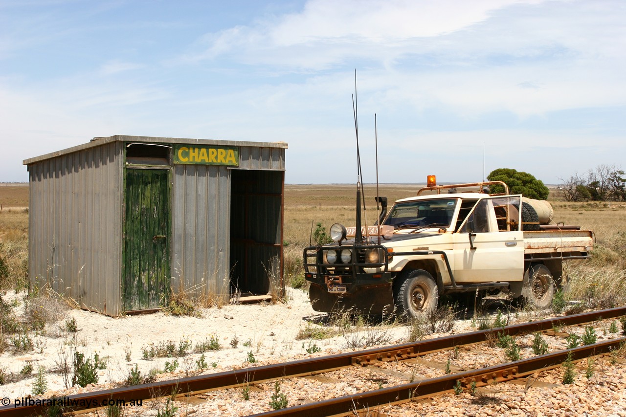 060113 2556
Charra at the 466.2 km, [url=https://goo.gl/maps/GpLTsHYeUymGtK5f7]Mallee style shelter building[/url]. Opened with the line on 13th February 1966 as a goods siding, reclassified as passing siding and extended, new goods loop siding constructed May 1982. 13th January 2006.
