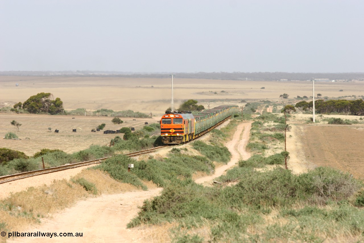 060113 2573
Ceduna, or Denial Bay area, empty gypsum train 6DD5 blasts up hill at the 440 km, crossing Carpenter Corner Rd with power from triple 1600/NJ class units 1604, NJ 3 and 1601. 1604 in Australian Railroad Group livery is a Clyde Engineering built EMD JL22C model serial 71-731, originally built as NJ class NJ 4. [url=https://goo.gl/maps/ULA2PjjKh6nhwHTdA]Location approximation[/url]. 13th January 2006.
Keywords: 1600-class;1604;Clyde-Engineering-Granville-NSW;EMD;JL22C;71-731;NJ-class;NJ4;