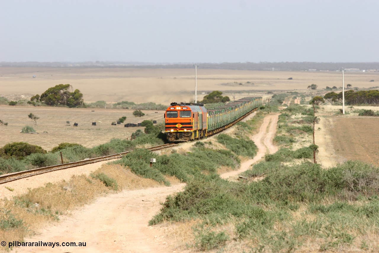 060113 2574
Ceduna, or Denial Bay area, empty gypsum train 6DD5 blasts up hill at the 440 km, crossing Carpenter Corner Rd with power from triple 1600/NJ class units 1604, NJ 3 and 1601. 1604 in Australian Railroad Group livery is a Clyde Engineering built EMD JL22C model serial 71-731, originally built as NJ class NJ 4. [url=https://goo.gl/maps/ULA2PjjKh6nhwHTdA]Location approximation[/url]. 13th January 2006.
Keywords: 1600-class;1604;Clyde-Engineering-Granville-NSW;EMD;JL22C;71-731;NJ-class;NJ4;