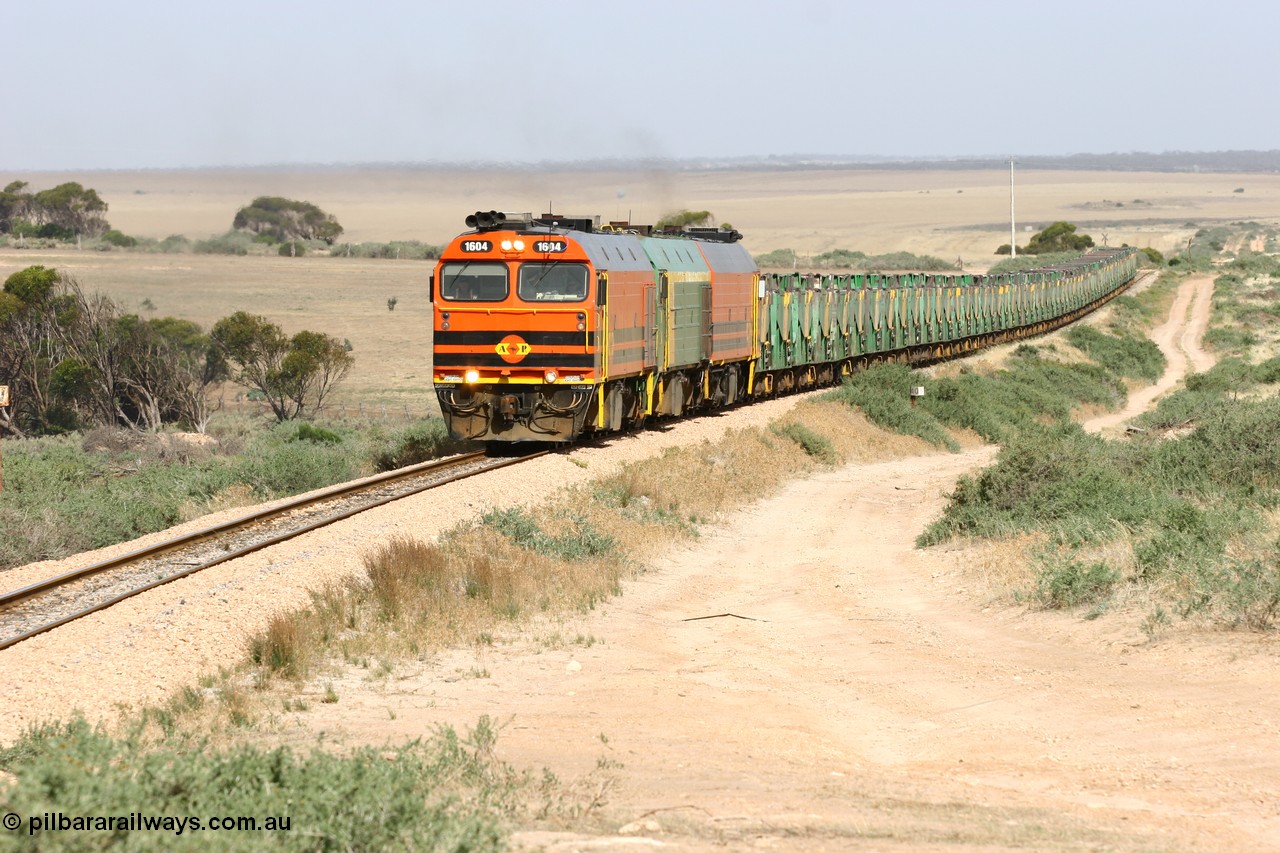 060113 2578
Ceduna, or Denial Bay area, empty gypsum train 6DD5 blasts up hill at the 440 km, west of Carpenter Corner Rd with power from triple 1600/NJ class units 1604, NJ 3 and 1601. 1604 in Australian Railroad Group livery is a Clyde Engineering built EMD JL22C model serial 71-731, originally built as NJ class NJ 4. [url=https://goo.gl/maps/ULA2PjjKh6nhwHTdA]Location approximation[/url]. 13th January 2006.
Keywords: 1600-class;1604;Clyde-Engineering-Granville-NSW;EMD;JL22C;71-731;NJ-class;NJ4;