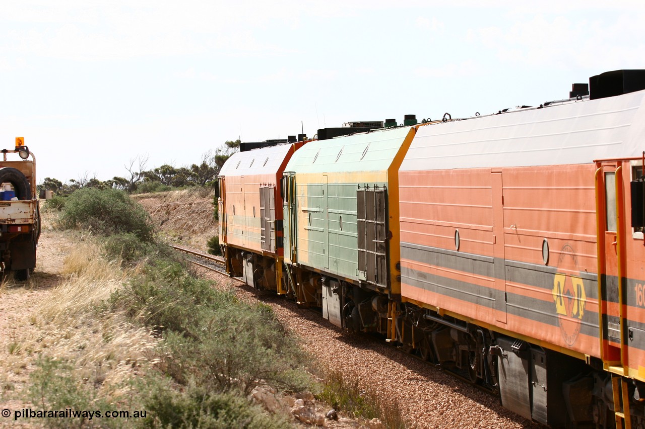060113 2586
Ceduna, or Denial Bay area, empty gypsum train 6DD5 blasts up hill at the 440 km, west of Carpenter Corner Rd with power from triple 1600/NJ class units 1604, NJ 3 and 1601. 1601 in Australian Railroad Group livery is a Clyde Engineering built EMD JL22C model serial 71-728, originally built as NJ class NJ 1. [url=https://goo.gl/maps/ULA2PjjKh6nhwHTdA]Location approximation[/url]. 13th January 2006.
Keywords: 1600-class;1601;Clyde-Engineering-Granville-NSW;EMD;JL22C;71-728;NJ-class;NJ1;