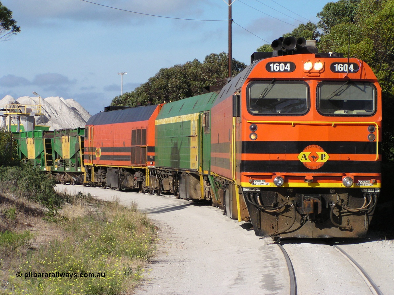 060113 P1010169
Thevenard, at the gypsum unloading site, 1604 leads a triple consist of Clyde Engineering EMD JL22C model 1600 / NJ class combination of 1604 serial 71-731 and originally NJ 4, NJ 3 serial 71-730 and 1601 serial 71-728 class leader NJ 1, all three units started on the Central Australia Railway in 1971 and were transferred to the Eyre Peninsula in 1981. 1604 and 1601 both renumbered in 2004. Friday 13th January 2006. Pope Searle photo.
Keywords: 1600-class;1604;Clyde-Engineering-Granville-NSW;EMD;JL22C;71-731;NJ-class;NJ4;