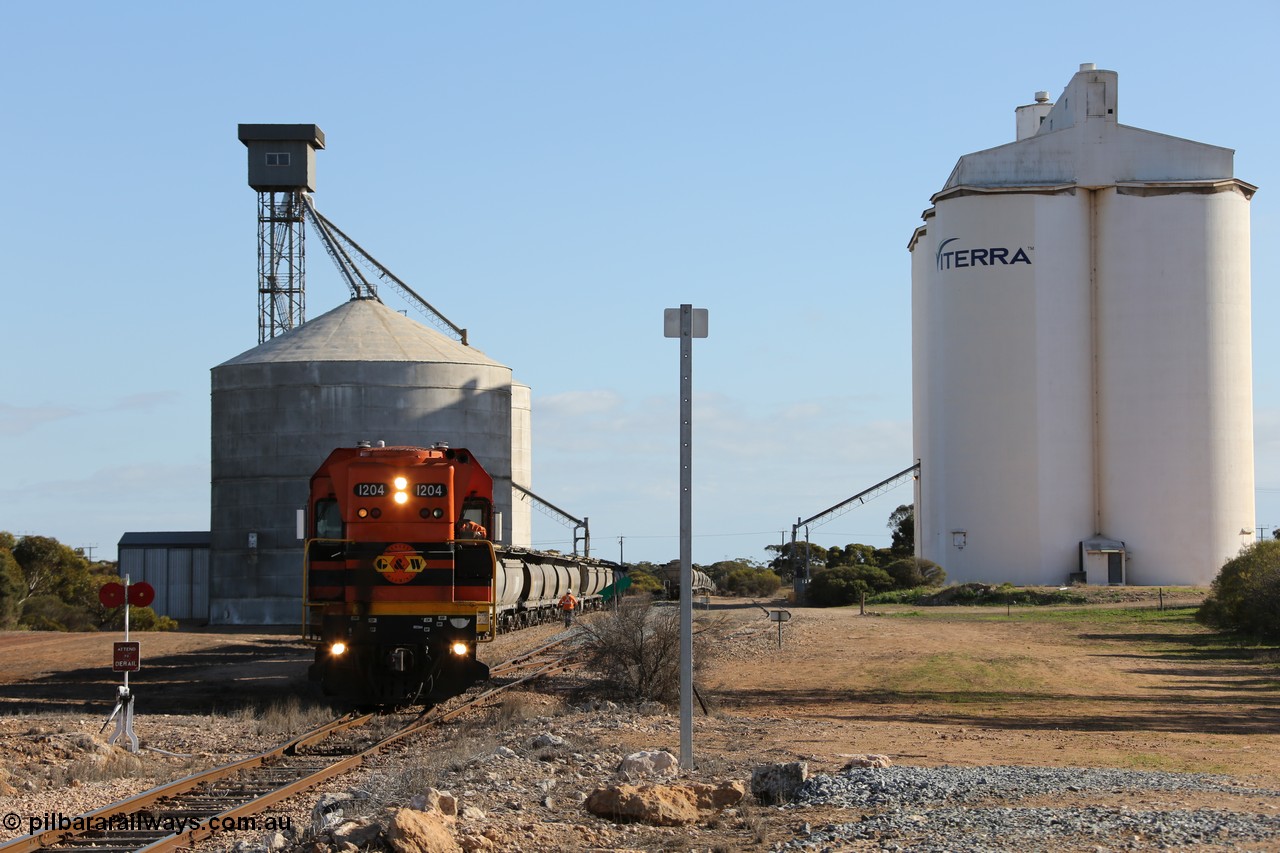 130704 0371
Kyancutta, south bound loaded grain train has stopped here to collect a loaded rack of fourteen grain waggons from the Ascom silo complex, Clyde Engineering built EMD G12C model 1204 serial 65-428 leads the train and was originally built in 1965 for Western Mining Corporation and operated by the WAGR as their A class A 1514.
Keywords: 1200-class;1204;Clyde-Engineering-Granville-NSW;EMD;G12C;65-428;A-class;A1514;