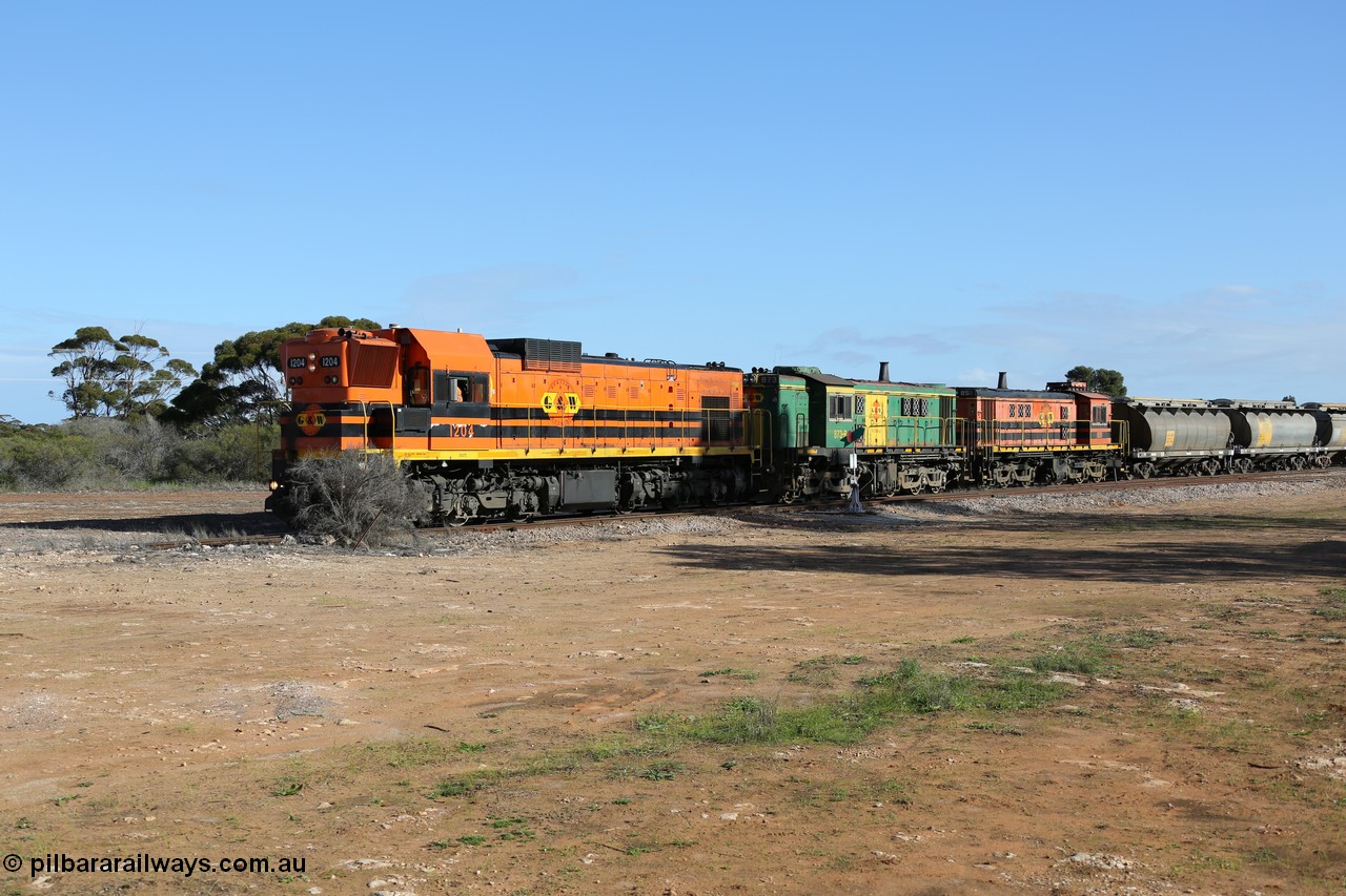 130704 0373
Kyancutta, south bound loaded grain train has stopped here to collect a loaded rack of fourteen grain waggons from the Ascom silo complex, Clyde Engineering built EMD G12C model 1204 serial 65-428 leads the train and was originally built in 1965 for Western Mining Corporation and operated by the WAGR as their A class A 1514.
Keywords: 1200-class;1204;Clyde-Engineering-Granville-NSW;EMD;G12C;65-428;A-class;A1514;