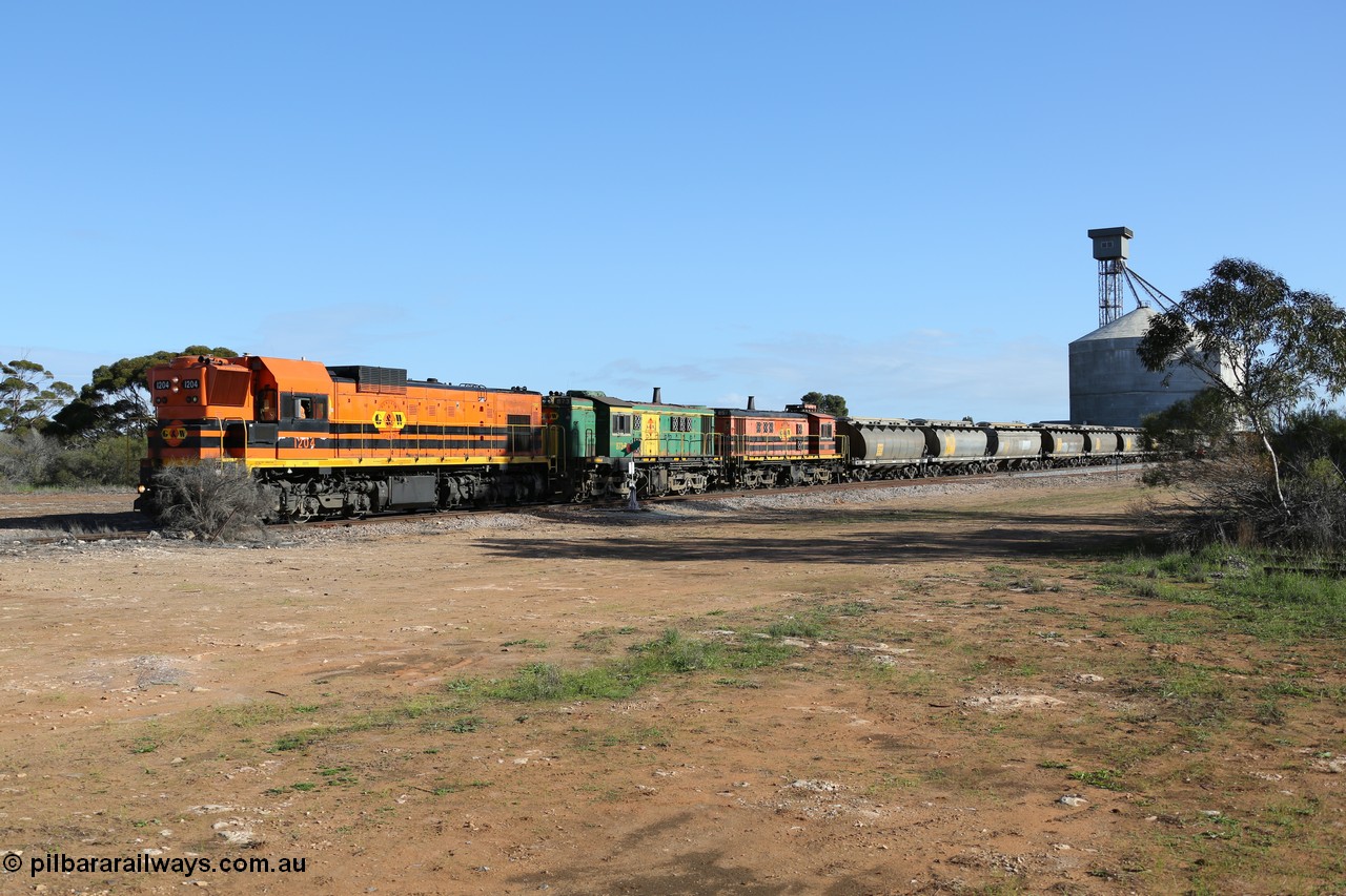 130704 0374
Kyancutta, south bound loaded grain train has stopped here to collect a loaded rack of fourteen grain waggons from the Ascom silo complex, Clyde Engineering built EMD G12C model 1204 serial 65-428 leads the train and was originally built in 1965 for Western Mining Corporation and operated by the WAGR as their A class A 1514.
Keywords: 1200-class;1204;Clyde-Engineering-Granville-NSW;EMD;G12C;65-428;A-class;A1514;