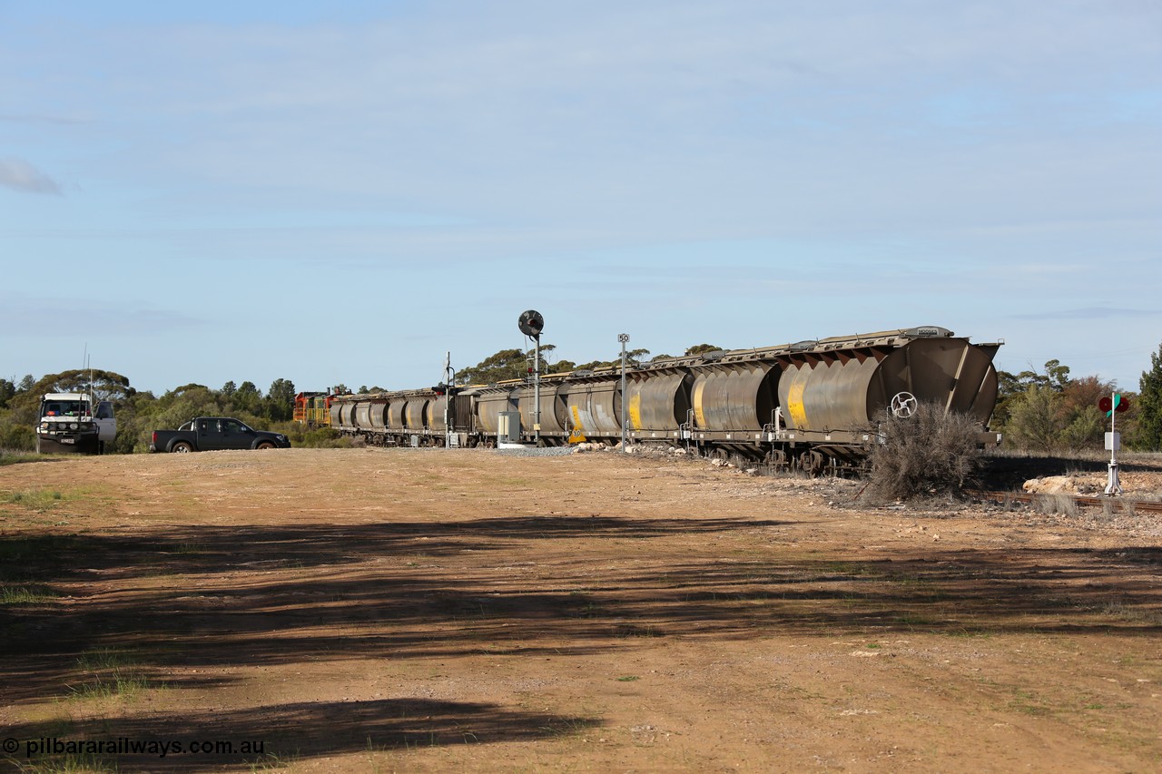 130704 0406
Kyancutta, south bound loaded grain train has stopped here to collect a loaded rack of grain waggons, seen here waiting for the points to be restored for the mainline across the Eyre Highway grade crossing and one of only three electric signals on the network, behind EMD 1204 and twin ALCo 830 units 873 and 851. 4th July 2013.
