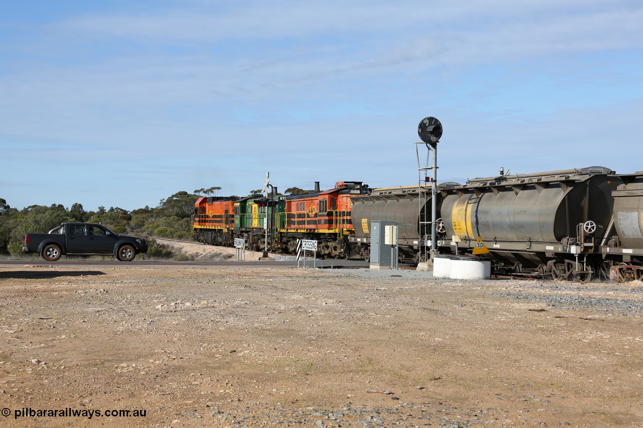 130704 0413
Kyancutta, south bound loaded grain train has stopped here to collect a loaded rack of grain waggons, seen here backing up to re-join the rest of the train on the mainline as it crosses the Eyre Highway grade crossing and one of only three electric signals on the network, behind EMD 1204 and twin ALCo 830 units 873 and 851. 4th July 2013.
