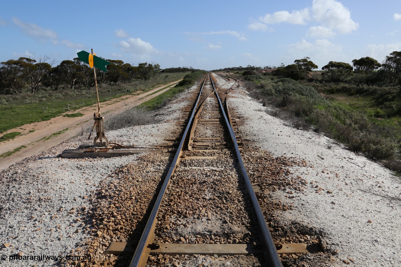 130704 0503
Moule, yard overview looking west from the east end points of the crossing loop, Moule located at the 445.6 km was opened in February 1966 when the Direct Line between Ceduna and Kevin was opened. From the left point lever and indicator, the crossing loop on the right and then the ballast pile in the distance. [url=https://goo.gl/maps/XvLsRfFyxbnmjHzq7]Location is here[/url]. 4th July 2013.
