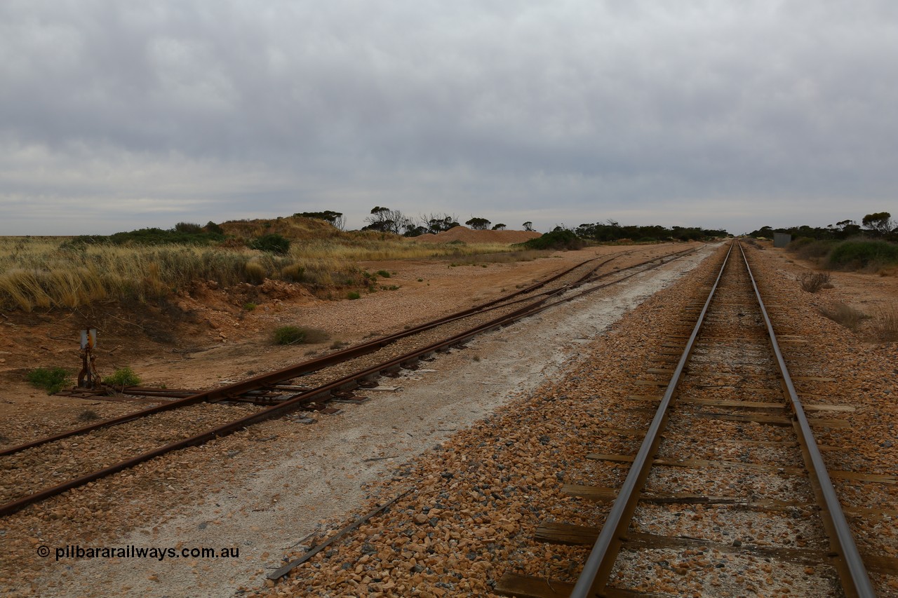 161109 1887
Moule, located at the 445.6 km, and opened on the 13th February 1966, the siding location once sported ballast loading bins during construction, looking towards Thevenard. Ballast is stockpiled on the left, opposite the station shed on the right.
