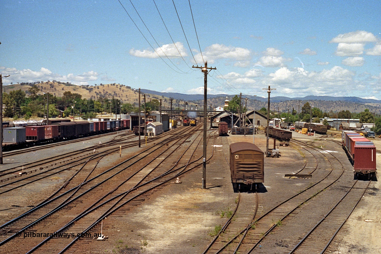 100-12
Albury station yard overview looking south from Wilson Street footbridge, NSWSRA standard gauge 44 class AE Goodwin ALCo model DL500B smokes up in the distance, tracks at right are, standard gauge with louvre vans leading down to goods shed, baulked dead end siding and siding with container waggons are broad gauge. [url=https://goo.gl/maps/nngpTA37VQekQpCt7]Geodata[/url].
Keywords: 44-class;AE-Goodwin;ALCo;DL500B;