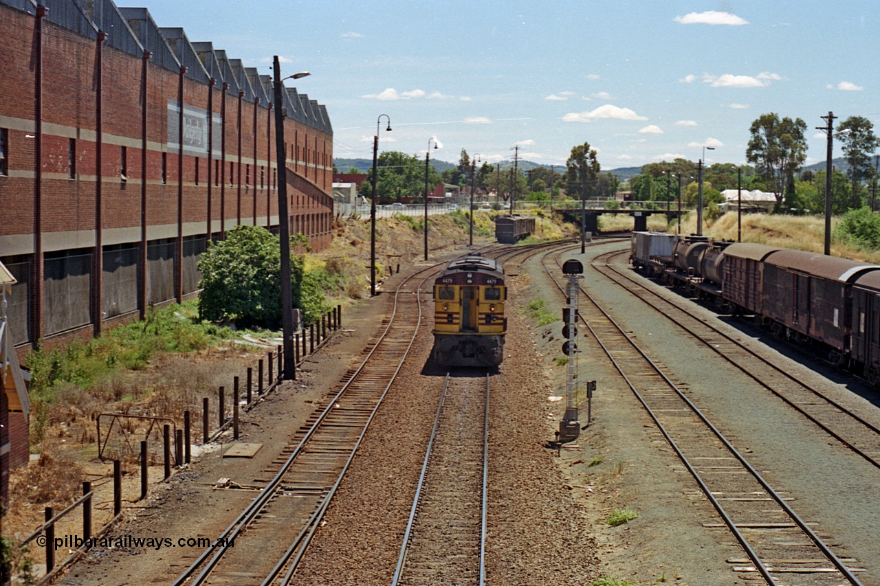 100-14
Albury yard, NSWSRA standard gauge 44 class 4479 AE Goodwin ALCo model DL500B serial G3421-19, readies for Inter-Capital Daylight banker duty, north end of yard looking north, from Wilson Street footbridge, signal post AY61, up shunting neck in the distance LHS, Dalgety's building on the left. [url=https://goo.gl/maps/nngpTA37VQekQpCt7]Geodata[/url].
Keywords: 44-class;4479;AE-Goodwin;ALCo;DL500B;G3421-19;