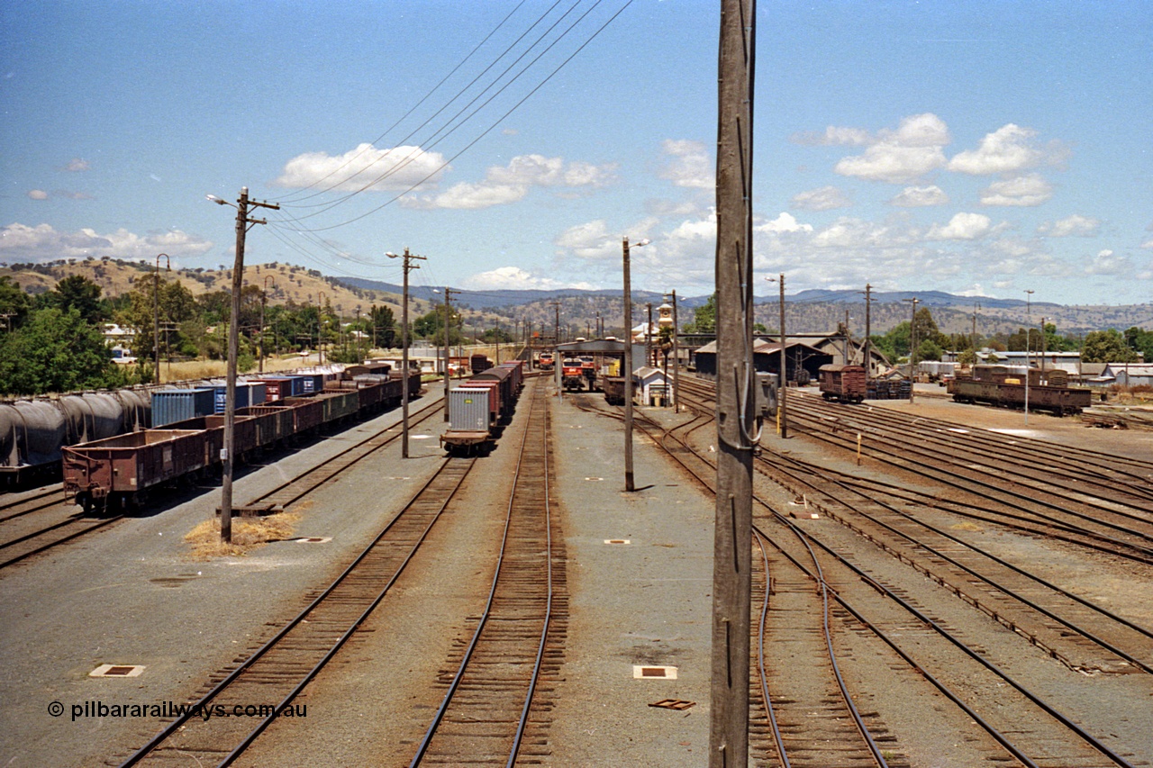 100-15
Albury station yard overview, looking south from Wilson Street footbridge, NSWSRA standard gauge 81 class locos in background, goods sheds on the right. [url=https://goo.gl/maps/nngpTA37VQekQpCt7]Geodata[/url].
Keywords: 81-class;