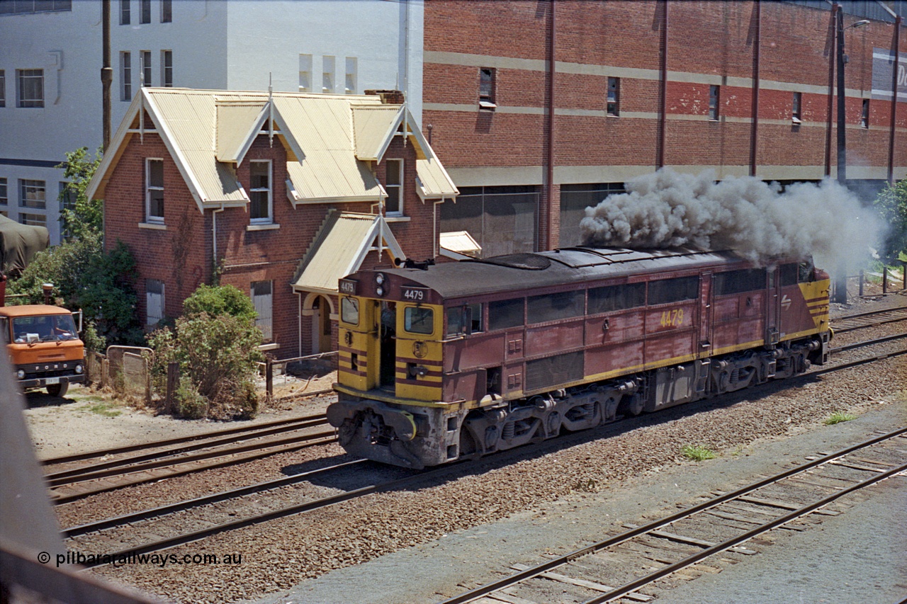 100-16
Albury yard, NSWSRA standard gauge 44 class 4479 AE Goodwin ALCo model DL500B serial G3421-19 smokes up, shunting back onto Inter-Capital Daylight, Dalgety's building behind, from Wilson Street footbridge, gatekeeper's cottage behind the loco. The cottage is a Victorian Neo-Gothic style and was located at 402 Wilson St and built in 1880 by Messrs Batstone and Brewer. Subsequently demolished in 1989. [url=https://goo.gl/maps/nngpTA37VQekQpCt7]Geodata[/url].
Keywords: 44-class;4479;AE-Goodwin;ALCo;DL500B;G3421-19;