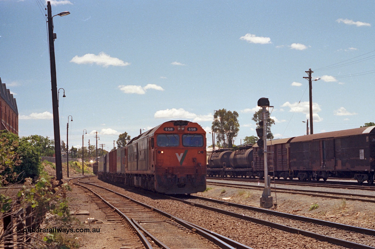 100-17
Albury yard, looking north from Wilson Street, track at left is the up shunting neck, Dalgety's building on the left, V/Line standard gauge G class G 518 Clyde Engineering EMD model JT26C-2SS serial 85-1231 arrives with Melbourne bound goods past signal post AY61. [url=https://goo.gl/maps/GD6wj4qXeCg5BFzr7]Geodata[/url].
Keywords: G-class;G518;Clyde-Engineering-Rosewater-SA;EMD;JT26C-2SS;85-1231;