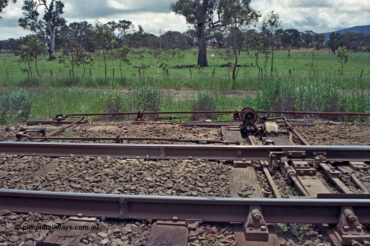 104-08
Buangor crossing loop, detail shot of point blades, rodding and signal wires and the interlocking arrangements at the west end points including plunger, detectors and electric switch lock.
