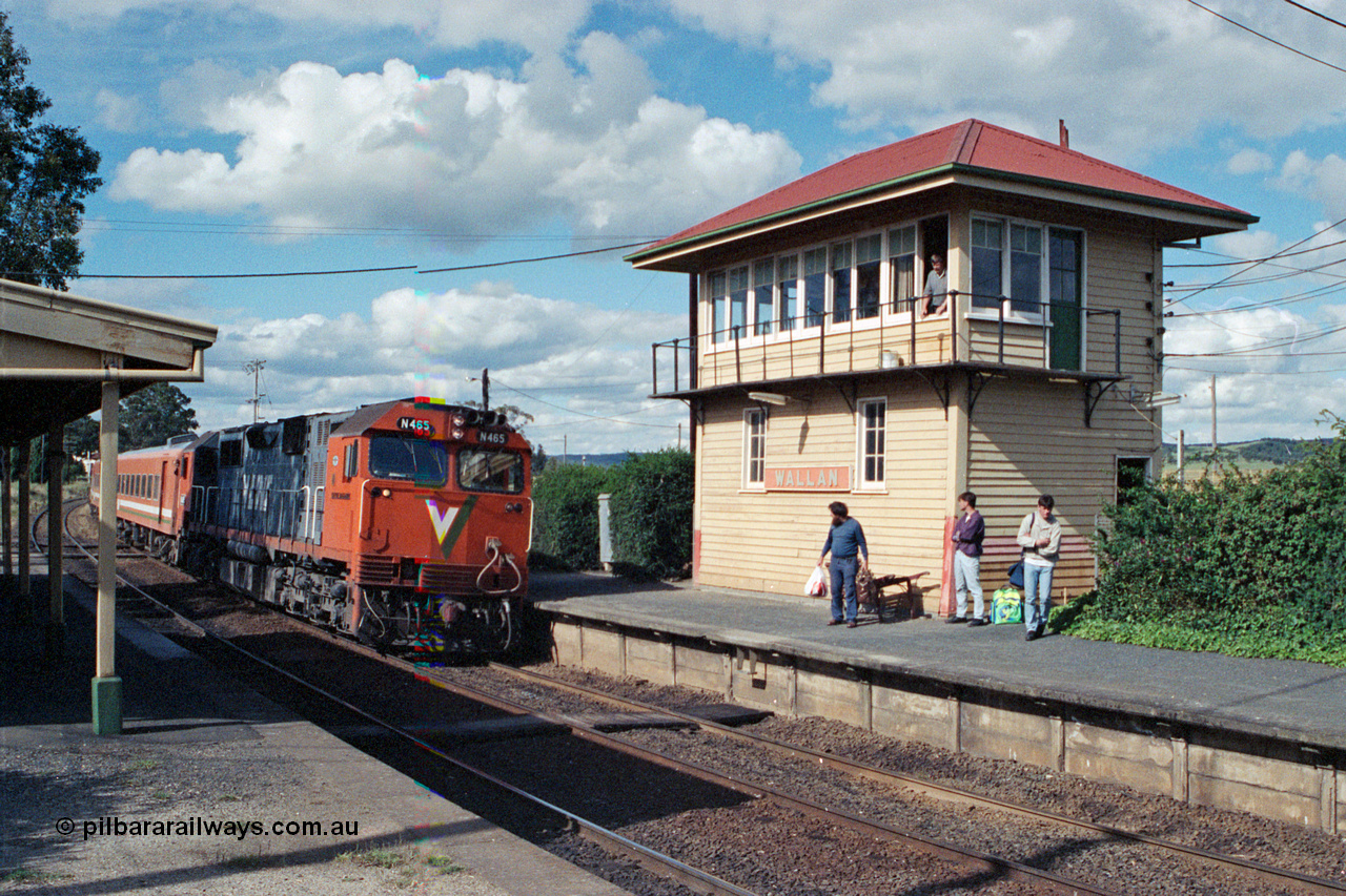 104-20
Wallan station overview looking in a down direction, broad gauge V/Line N class loco N 465 'City of Ballaarat' with serial 86-1194 a Clyde Engineering Somerton Victoria built EMD model JT22HC-2 and N set with an up Albury pass, signaller watches from the elevated signal box built in 1916 with a 40 lever A pattern frame replacing a 20 lever frame on the Down platform.
Keywords: N-class;N465;Clyde-Engineering-Somerton-Victoria;EMD;JT22HC-2;86-1194;