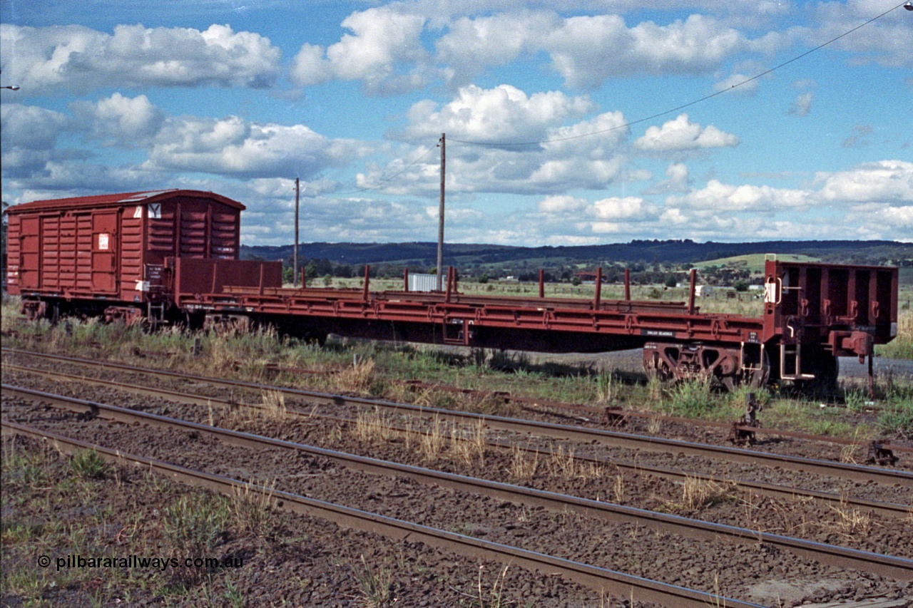 104-24
Wallan, V/Line broad gauge VFLX type bogie bulk end flat waggon VFLX?? loaded with rail and a VLBY type bogie louvre van on No.3 Rd. The VFLX is fitted with a lashing rail, possibly ex SFX / VFMX panelboard flat waggon.
Keywords: VFLX-type;VLBY-type;Victorian-Railways-Newport-WS;FLX-type;