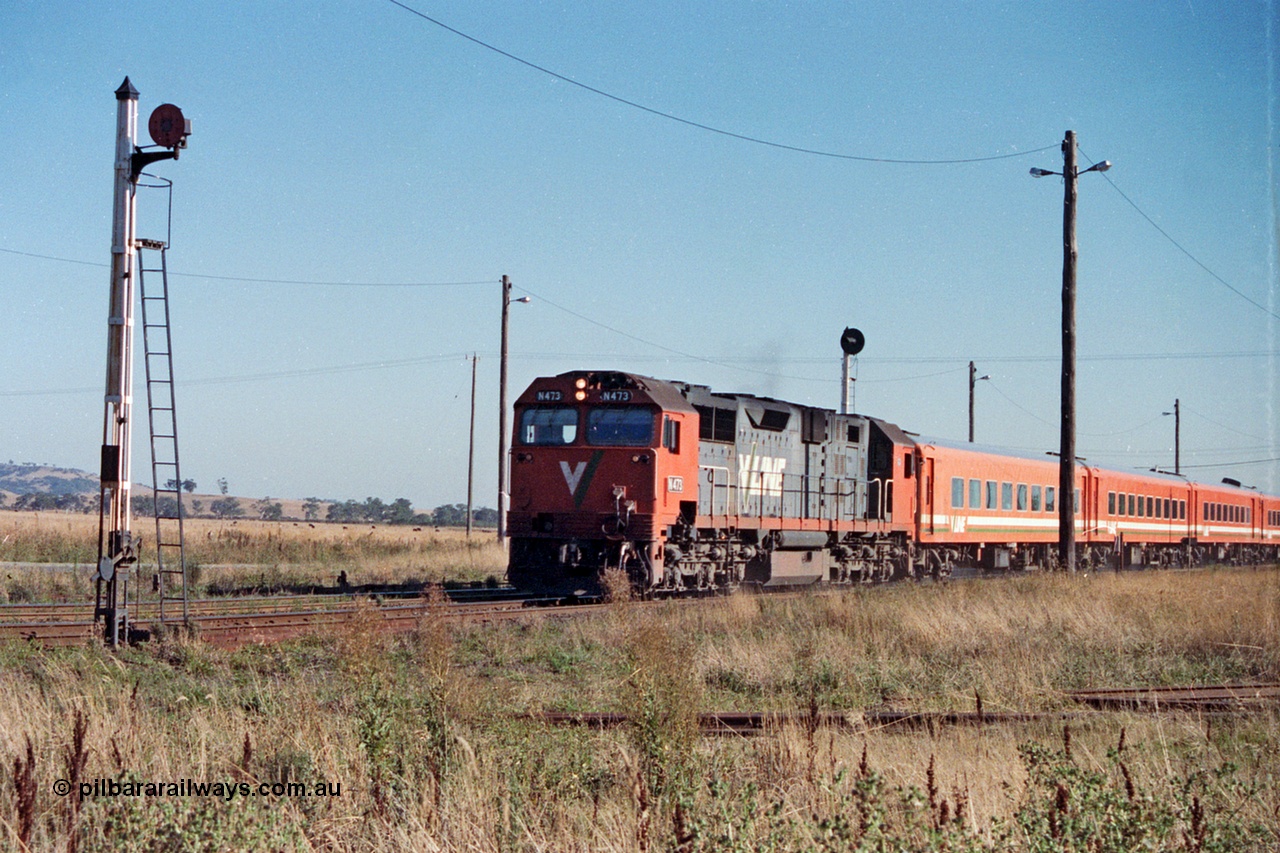 105-03
Wallan, V/Line broad gauge N class N 473 'City of Warragul' Clyde Engineering EMD model JT22HC-2 serial 87-1202 with N set on a down pass, redundant disc signal post 11 at left with searchlight signal post 9 above locomotive.
Keywords: N-class;N473;Clyde-Engineering-Somerton-Victoria;EMD;JT22HC-2;87-1202;