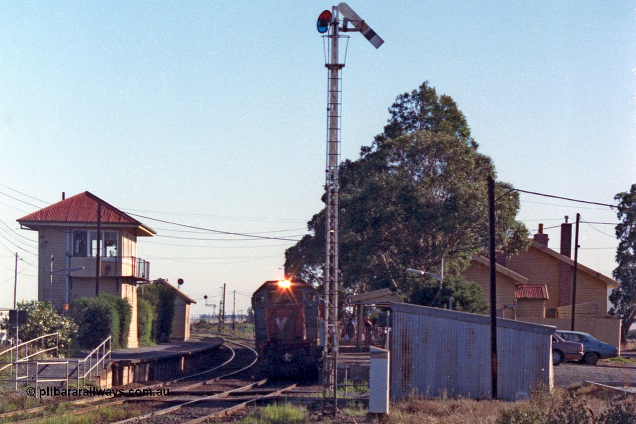 105-04
Wallan, V/Line broad gauge P class P 14 Clyde Engineering EMD model G18HBR serial 84-1208 rebuilt from T 330 Clyde Engineering EMD model G8B serial 56-85 stands at the down platform with passenger train 8323, station building at right, gangers trolley shed and elevated signal box, semaphore signal post 12 pulled off for the move.
Keywords: P-class;P14;Clyde-Engineering-Somerton-Victoria;EMD;G18HBR;84-1208;rebuild;