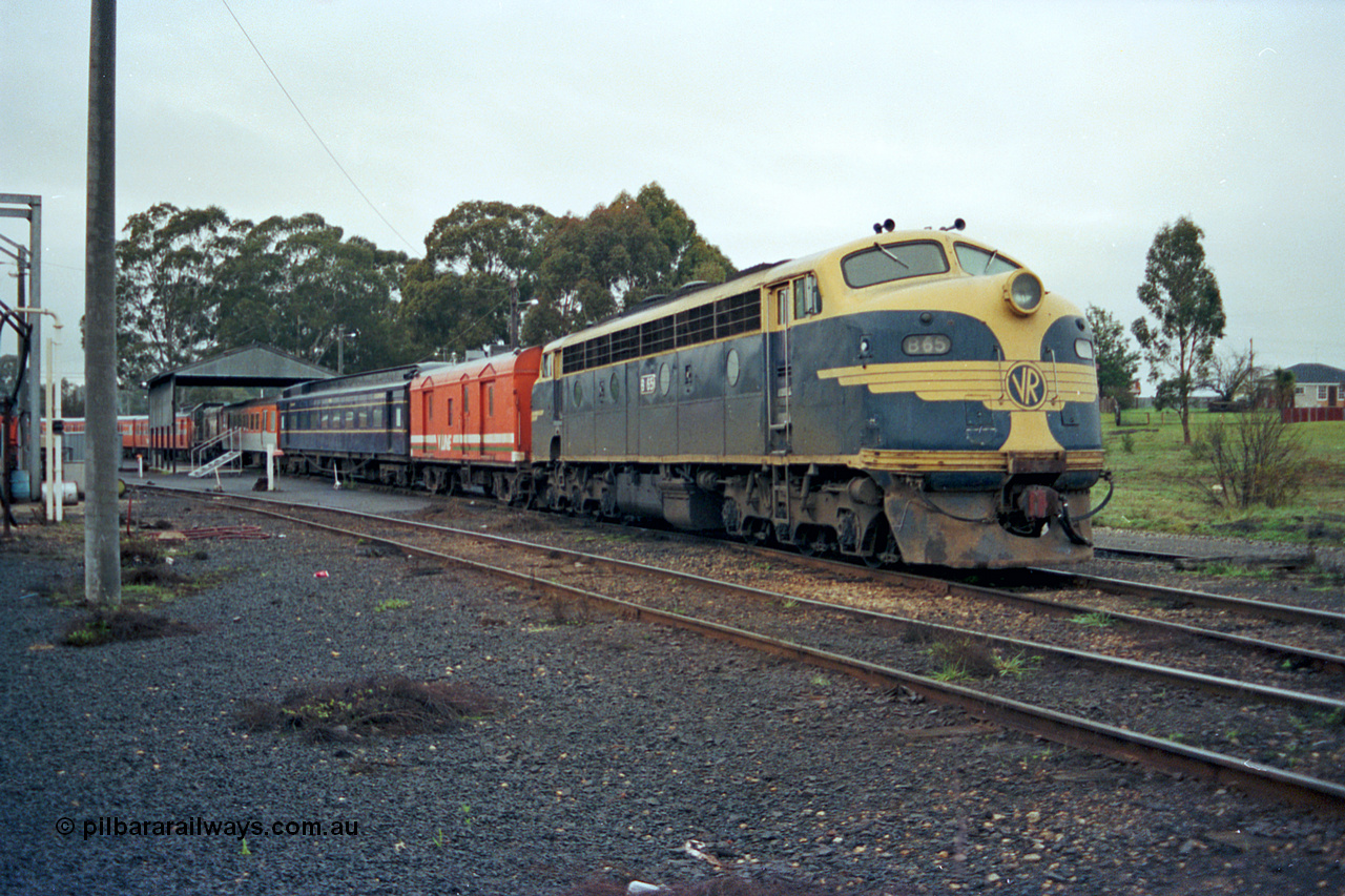 106-17
Seymour broad gauge passenger stabling yard, V/Line B class loco B 65 Clyde Engineering EMD model ML2 serial ML2-6 still in VR or Victorian Railways blue and gold livery with the stabled scratch set, CP class bogie guards van, AE class and MTH class bogie passenger carriages.
Keywords: B-class;B65;Clyde-Engineering-Granville-NSW;EMD;ML2;ML2-6;bulldog;CP-van;AE-class;MTH-class;