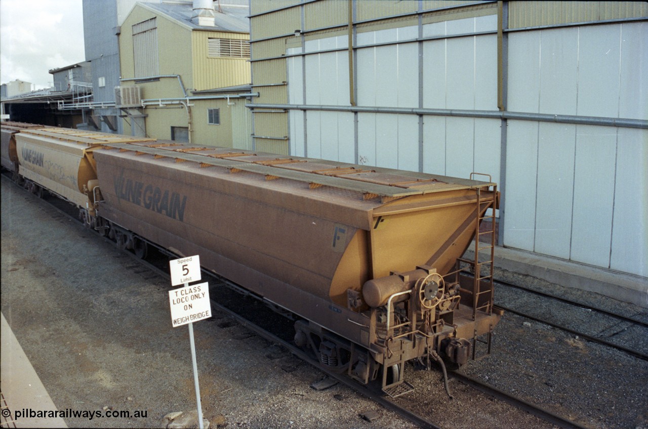107-25
Echuca yard view, Sidings A, broad gauge V/Line Grain VHGF type bogie grain waggon VHGF 575, hand brake end and roof detail, elevated view, weighbridge road.
Keywords: VHGF-type;VHGF575;