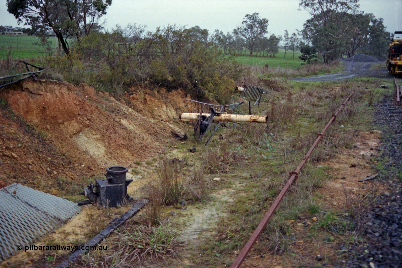 109-09
Broadford Loop, standard gauge, damaged signal bridge remains in drain, point rodding for ballast loading siding and catch points just visible on the right hand edge, looking south
