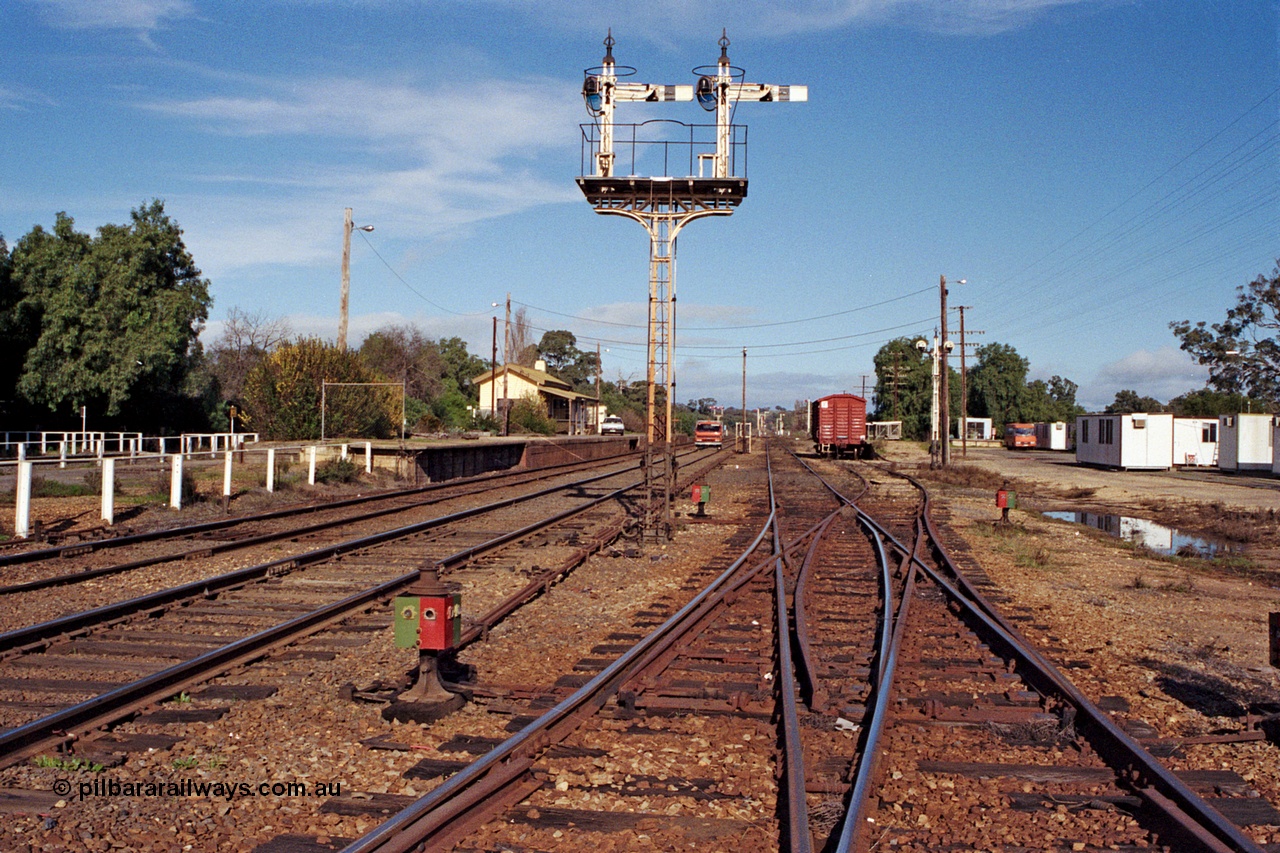 109-20
Avenal station yard overview looking south, prior to rationalisation, semaphore signal post 10 and disc signal post 9 facing away from camera, point indicators and rodding, double compound points, gang camp dongas, Hi-Rail truck on mainline.
