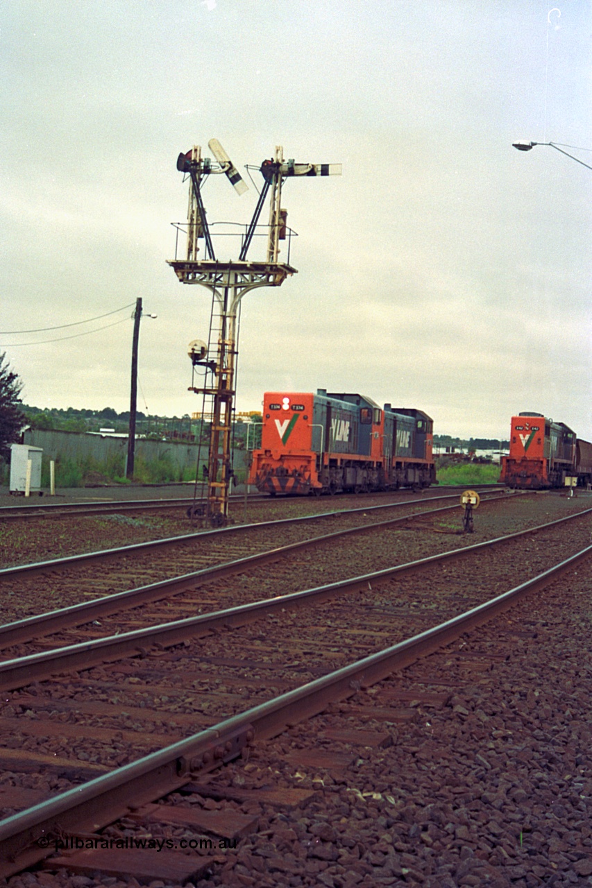 111-10
North Geelong grain arrivals yard, V/Line broad gauge locos T class T 374 Clyde Engineering EMD model G8B serial 64-329 and T class 3?? run back toward North Geelong C Box bound for the loco depot framed between semaphore post 13, ground dwarf disc signal 12 and 9192 up Mt Gambier goods train.
Keywords: T-class;T374;Clyde-Engineering-Granville-NSW;EMD;G8B;64-329;