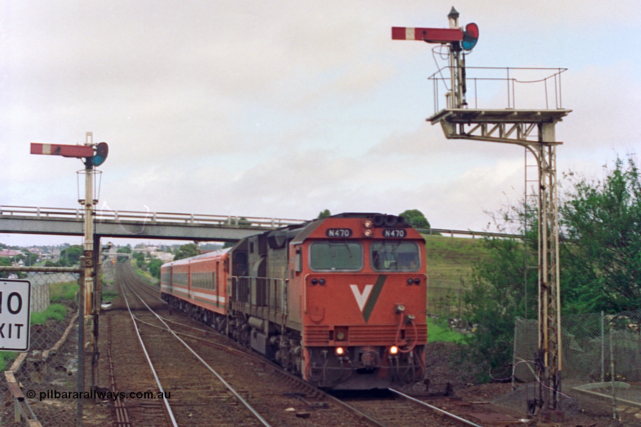 111-24
North Geelong station, V/Line broad gauge N class N 470 'City of Wangaratta' Clyde Engineering EMD model JT22HC-2 serial 86-1199 and N set work an up Geelong passenger train to Melbourne as it splits semaphore signal posts 33 and 34, driver only operation.
Keywords: N-class;N470;Clyde-Engineering-Somerton-Victoria;EMD;JT22HC-2;86-1199;