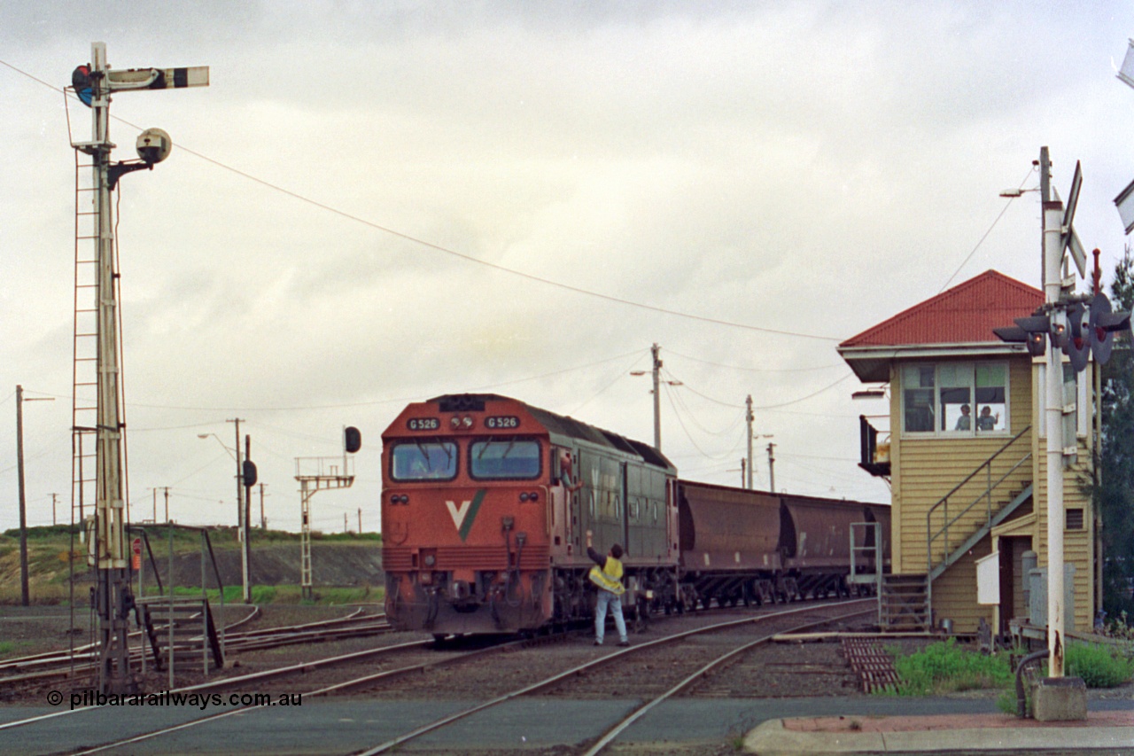 111-30
North Geelong C Box, V/Line broad gauge down grain train 9121 departs the yard behind G class G 526 Clyde Engineering EMD model JT26C-2SS serial 88-1256 as the driver obtains the electric staff for the section to Gheringhap, semaphore signal post 16, level crossing and point rodding.
Keywords: G-class;G526;Clyde-Engineering-Somerton-Victoria;EMD;JT26C-2SS;88-1256;