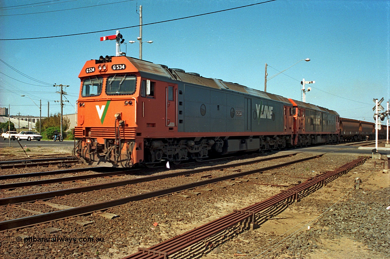 112-18
North Geelong C Box, V/Line broad gauge G class G 534 Clyde Engineering EMD model JT26C-2SS serial 88-1264 leads sister G class across Separation Street with an empty grain train departing, point rodding in foreground.
Keywords: G-class;G534;Clyde-Engineering-Somerton-Victoria;EMD;JT26C-2SS;88-1264;