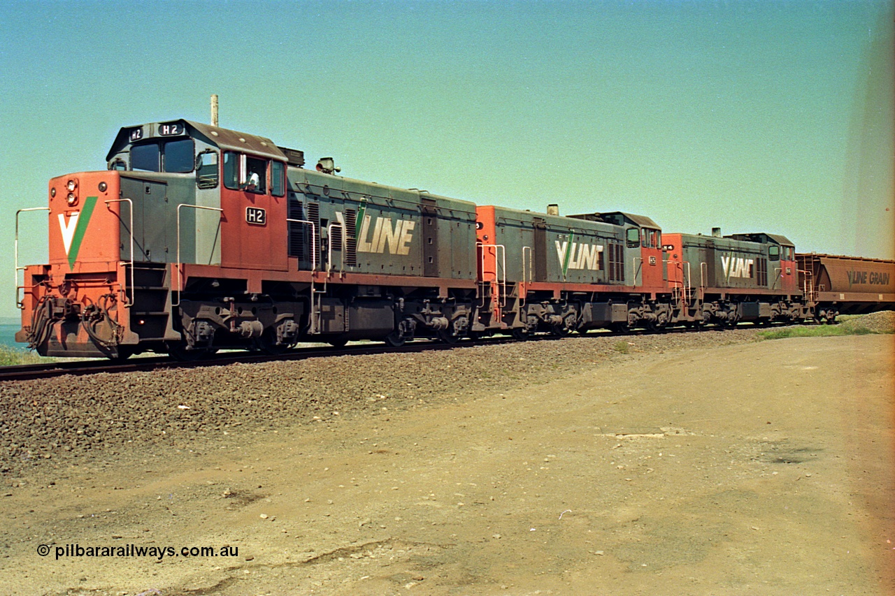 112-29
North Geelong grain loop, V/Line broad gauge locos H class H 2 Clyde Engineering EMD model G18B serial 68-630, H 5 serial 68-632 and H 4 serial 68-633 shunt around the grain loop unloading a grain train.
Keywords: H-class;H2;Clyde-Engineering-Granville-NSW;EMD;G18B;68-630;H5;68-632;H4;68-633;