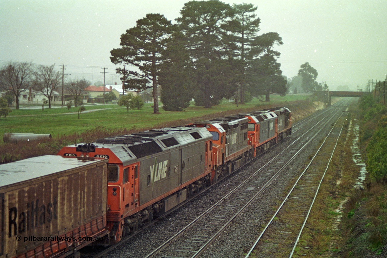 113-05
Ballarat East loco depot, Queen St bridge in distance, line at right is the former Eureka line, V/Line broad gauge up Adelaide goods train 9150 behind the quad CGCG combo of C class C 506 Clyde Engineering EMD model GT26C serial 76-829, G class G 538 Clyde Engineering EMD model JT26C-2SS serial 89-1271, C class C 510 serial 76-833 and G class G 513 serial 85-1241, in miserable conditions, poor quality.
Keywords: G-class;G513;Clyde-Engineering-Rosewater-SA;EMD;JT26C-2SS;85-1241;
