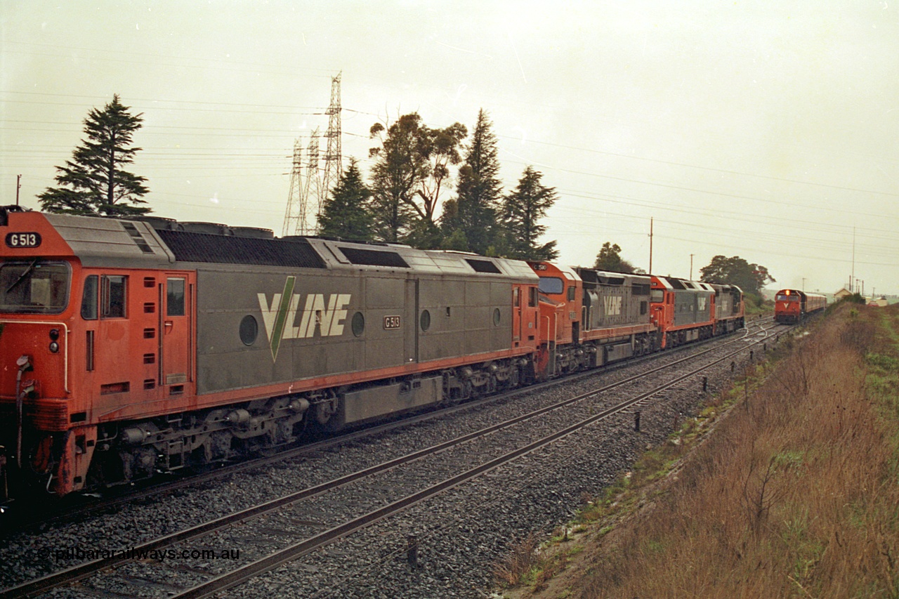 113-08
Warrenheip, V/Line broad gauge up Adelaide goods train 9150 behind the quad CGCG combo of C class C 506 Clyde Engineering EMD model GT26C serial 76-829, G class G 538 Clyde Engineering EMD model JT26C-2SS serial 89-1271, C class C 510 serial 76-833 and G class G 513 serial 85-1241, in miserable conditions, wait as a down passenger train with N class N 472 'City of Sale' Clyde Engineering EMD model JT22HC-2 serial 87-1201 and double N set passes.
Keywords: G-class;G513;Clyde-Engineering-Rosewater-SA;EMD;JT26C-2SS;85-1241;