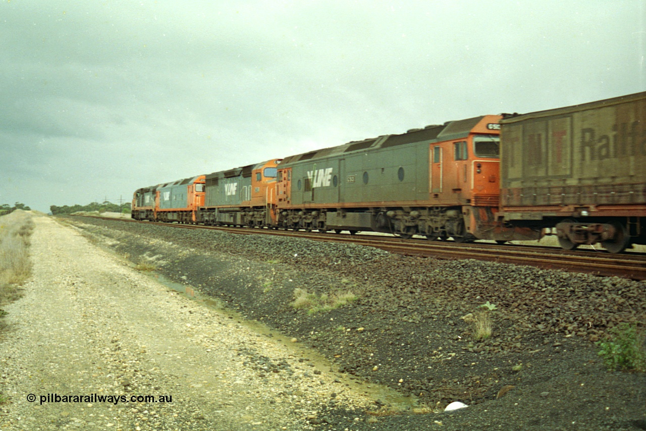 113-20
Parwan Loop, V/Line broad gauge up Adelaide goods train 9150 behind the quad CGCG combo of C class C 506 Clyde Engineering EMD model GT26C serial 76-829, G class G 538 Clyde Engineering EMD model JT26C-2SS serial 89-1271, C 510 serial 76-833 and G 513 serial 85-1241, in miserable conditions, poor quality, trailing shot.

