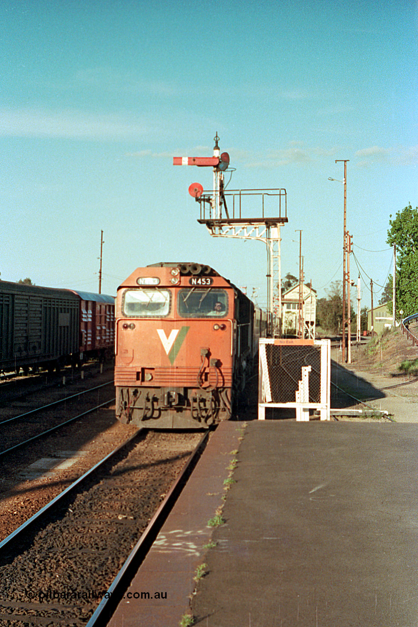 114-26
Benalla, V/Line broad gauge N class N 453 'City of Albury' Clyde Engineering EMD model JT22HC-2 serial 85-1221 with an up Albury passenger train arrives under the down home semaphore signal post 11, B Box and the workshops are visible in the distance, the disc signal on post 11 is for the loco and repair shop roads.
Keywords: N-class;N453;Clyde-Engineering-Somerton-Victoria;EMD;JT22HC-2;85-1221;