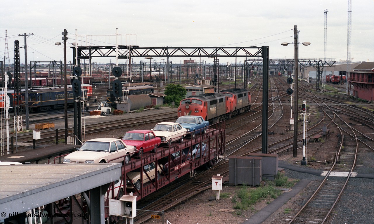 116-07
Spencer Street Station, view looking south from flyover, V/Line broad gauge A class A 62 runs light engine, in the background is a 'Tea Cup' V/Line liveried N set couple to current V/Line liveried N set, in the background are stored Y and T class locomotives.
