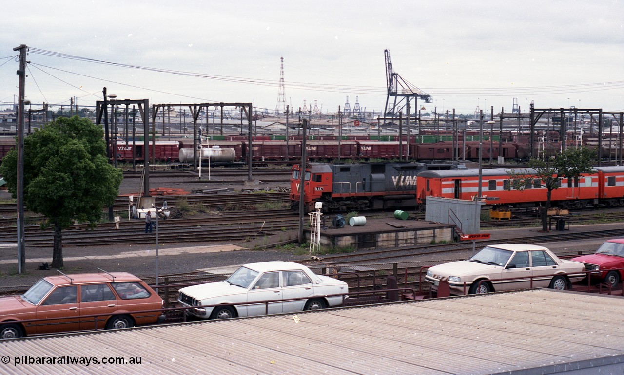 116-13
Spencer Street Station, view from flyover looking south, V/Line broad gauge N class N 457 'City of Mildura' Clyde Engineering EMD model JT22HC-2 serial 85-1225 shunts past stabled 'Tea Cup' liveried V/Line H set SH 29, view across Melbourne Goods Yard with Port of Melbourne in the distance, Motorail waggons on 'The Overland' in the foreground.
Keywords: N-class;N457;Clyde-Engineering-Somerton-Victoria;EMD;JT22HC-2;85-1225;