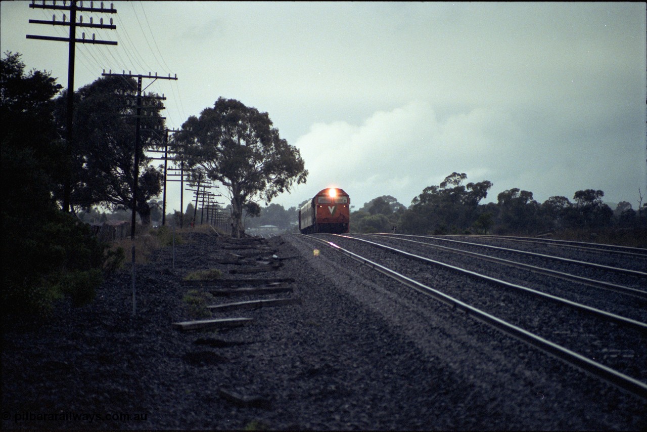 117-01
Somerton, V/Line N class loco N 456 'City of Colac' with serial 85-1224 a Clyde Engineering Somerton Victoria built EMD model JT22HC-2 with up Albury Pass train, standard gauge line on far right, in driving rain.
Keywords: N-class;N456;Clyde-Engineering-Somerton-Victoria;EMD;JT22HC-2;85-1224;