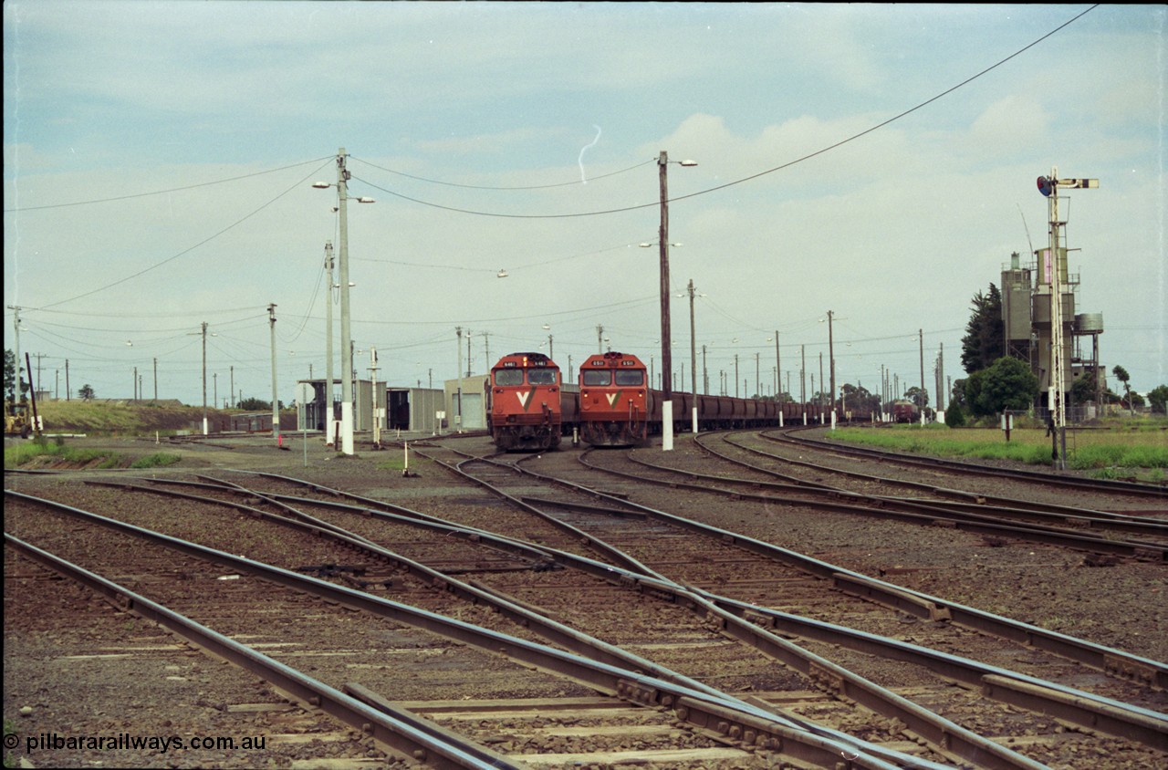 119-03
Nth Geelong yard overview, empty grain trains, V/Line broad gauge N class shunts train back into the Sorting Yard, a G class sits on an empty grain train, looking from Nth Geelong C towards Geelong, grain loop roads and Loop Line at left, semaphore signal post 17 on the right.
Keywords: N-class;N461;Clyde-Engineering-Somerton-Victoria;EMD;JT22HC-2;86-1190;