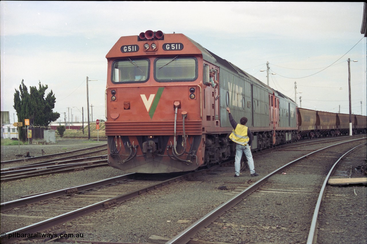 119-05
North Geelong C Box, V/Line broad gauge Series 1 G class leader G 511 Clyde Engineering EMD model JT26C-2SS serial 84-1239 and G 538 Clyde Engineering EMD model JT26C-2SS serial 89-1271 work down empty grain train 9123 as it departs and takes the electric staff for the Gheringhap section off the Nth Geelong C signaller.
Keywords: G-class;G511;Clyde-Engineering-Rosewater-SA;EMD;JT26C-2SS;84-1239;