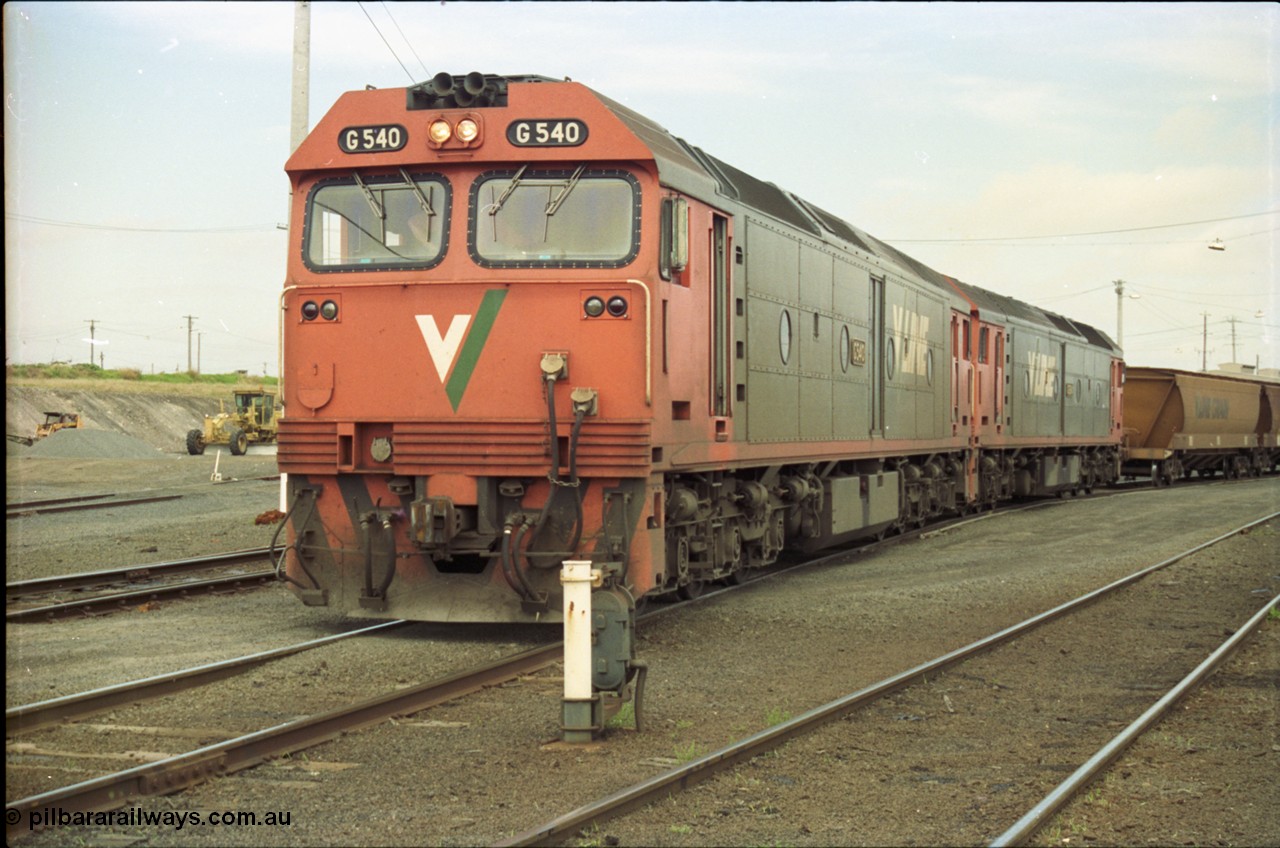 119-09
North Geelong yard, V/Line broad gauge locos G class G 540 Clyde Engineering EMD model JT26C-2SS serial 89-1273 and another G class waiting for shunters to couple up to empty grain rake to form down grain train 9125, ground dwarf signal 20.
Keywords: G-class;G540;Clyde-Engineering-Somerton-Victoria;EMD;JT26C-2SS;89-1273;