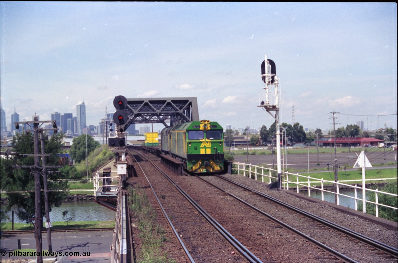 119-22
Maribyrnong River bridge, signal post 162, Australian National broad gauge locos BL class BL 29 Clyde Engineering EMD model JT26C-2SS serial 83-1013 and 700 class 703 AE Goodwin ALCo model DL500G serial G6059-1 working down Adelaide bound goods train 9145 across the river.
Keywords: BL-class;BL29;Clyde-Engineering-Rosewater-SA;EMD;JT26C-2SS;83-1013;